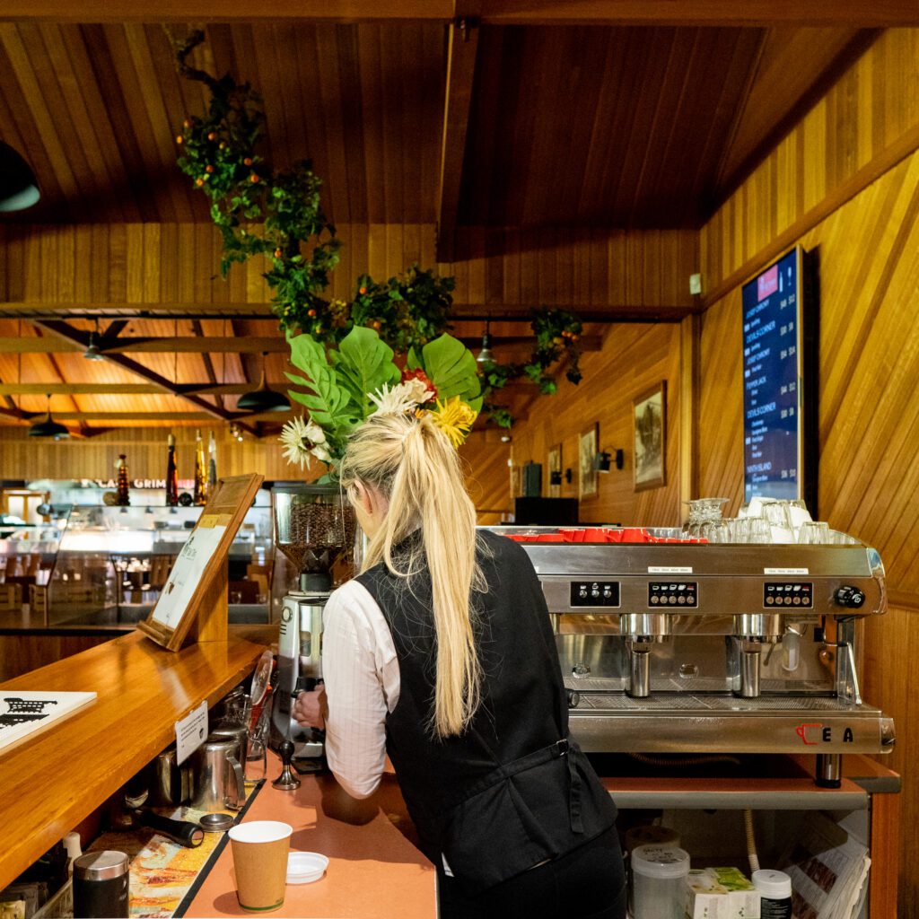Leah making coffee with Kauri Bistro visible in background