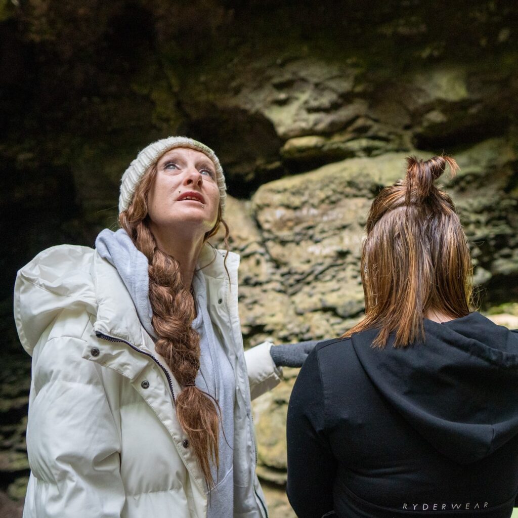 Two women at Trowutta Arch with one looking up at the canopy