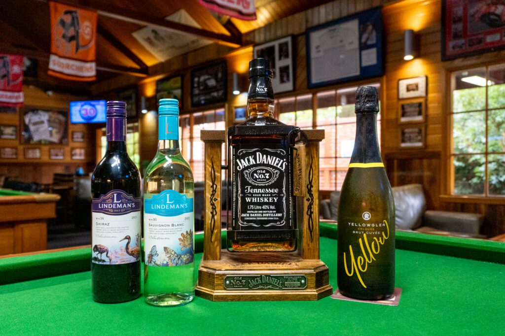 Wines and Jack Daniels in wooden swing cradle on pool table in Millers Sports Bar