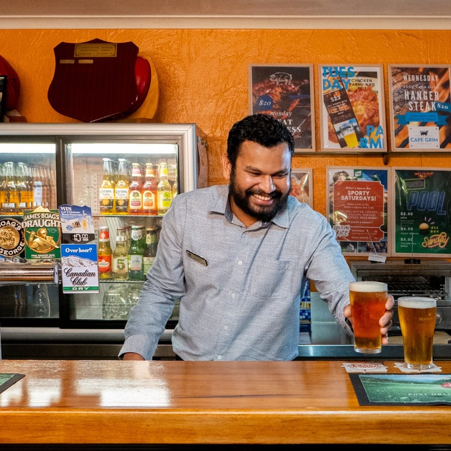 Duty Manager Kasun serving beer in Millers Sports Bar