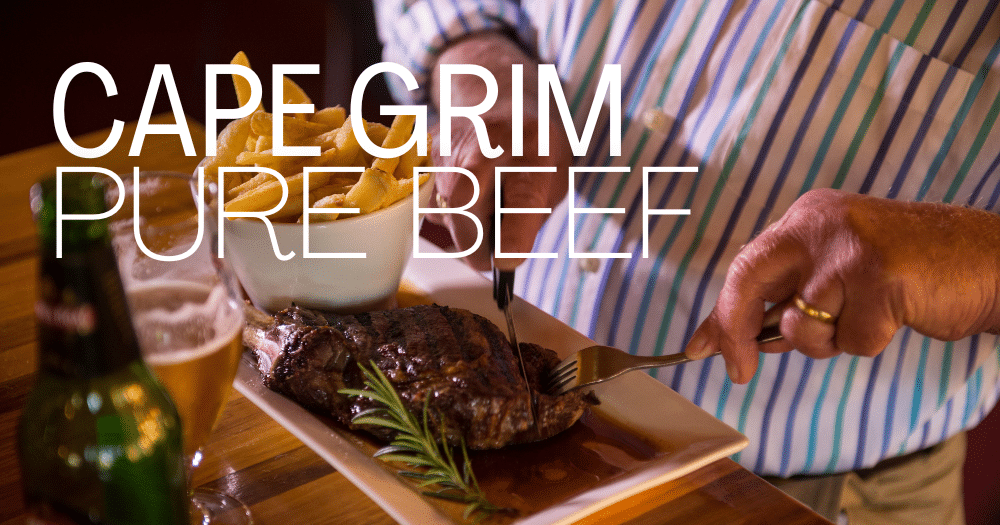 Man cutting Cape Grim beef steak with side of chips