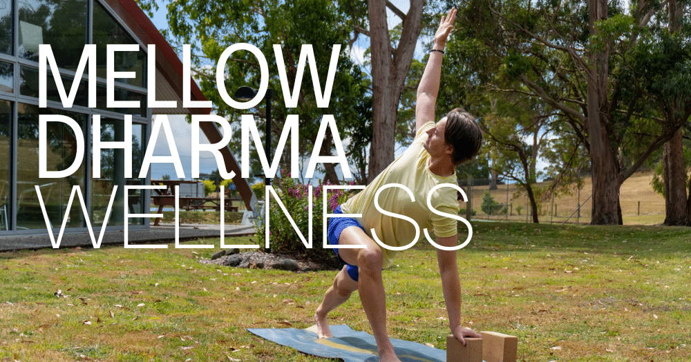 Alex from Mellow Dharma posing on his yoga mat outside the Tall Timbers pool building