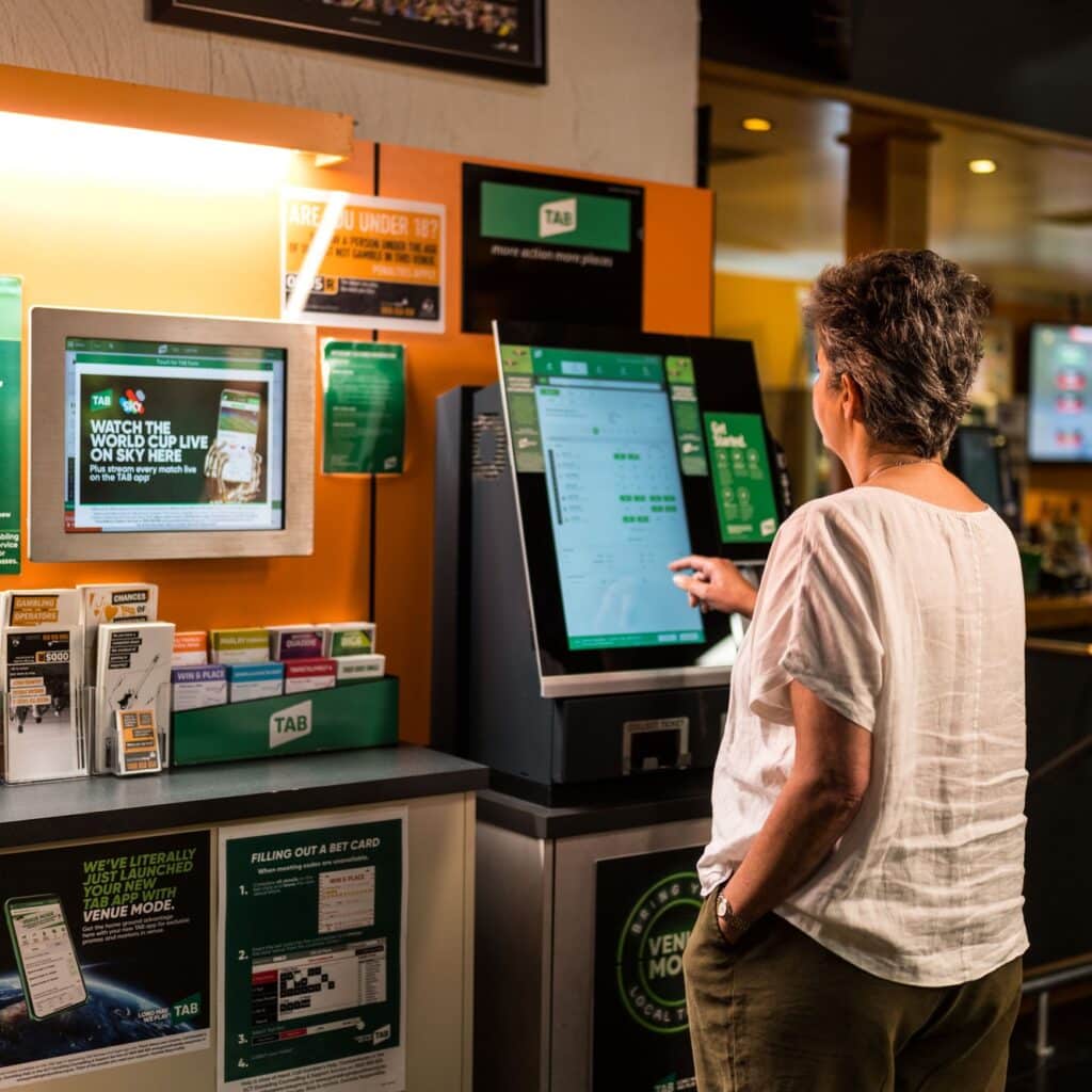 Woman using Keno machine in Millers Sports Bar